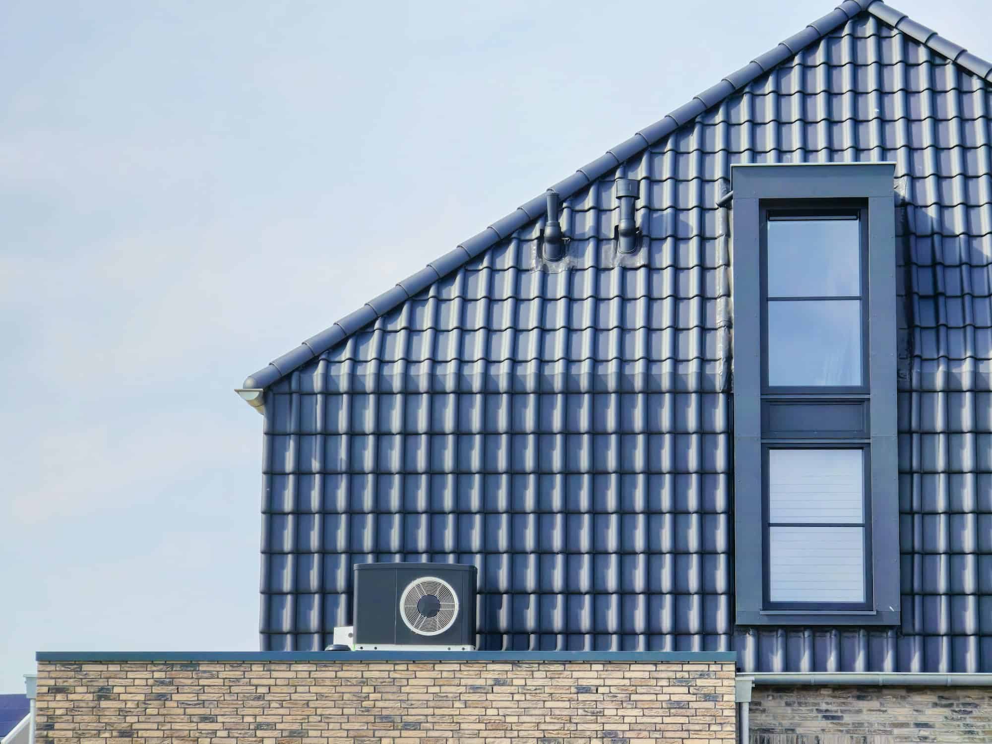 air source heat pump unit installed outdoors at a modern home with bricks in the Netherlands